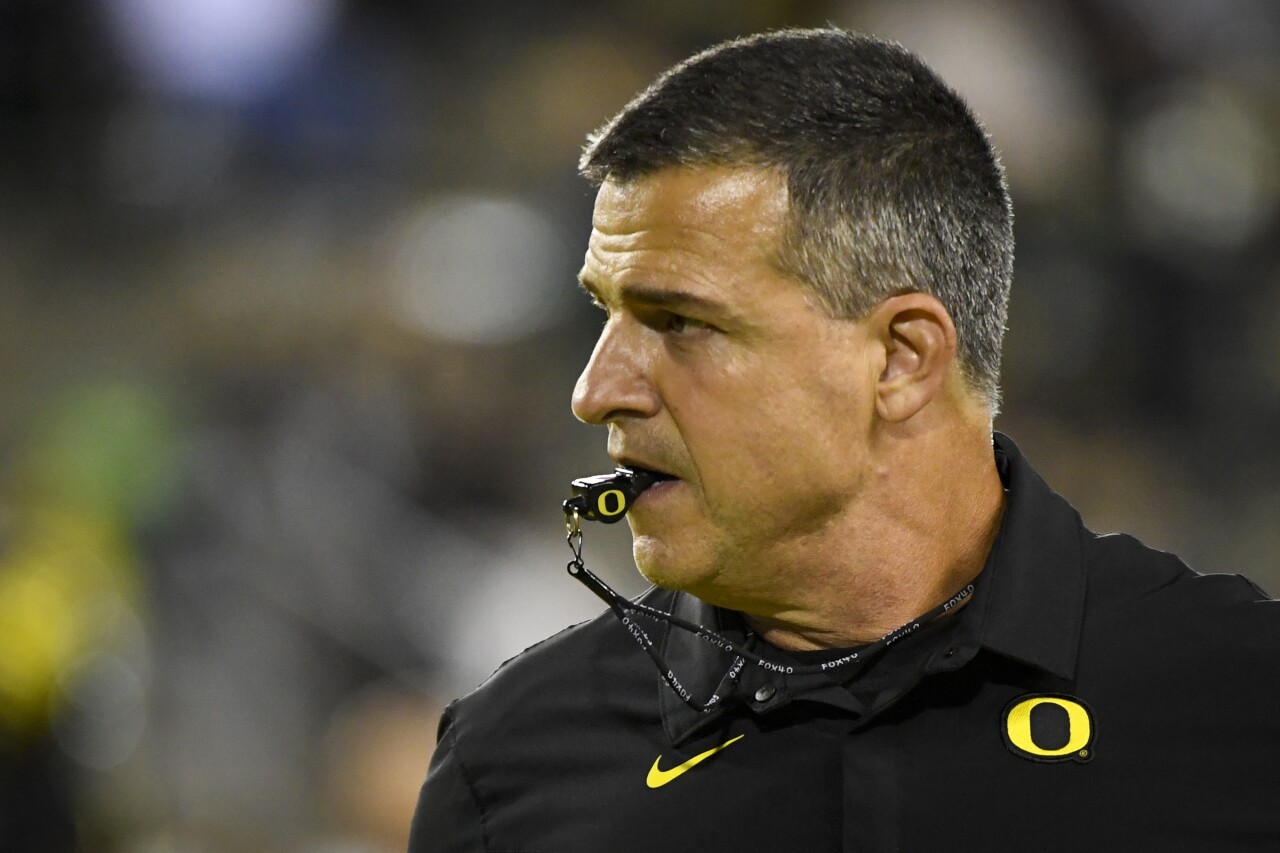 Oregon Ducks head coach Mario Cristobal with whistle in his mouth before game in 2021