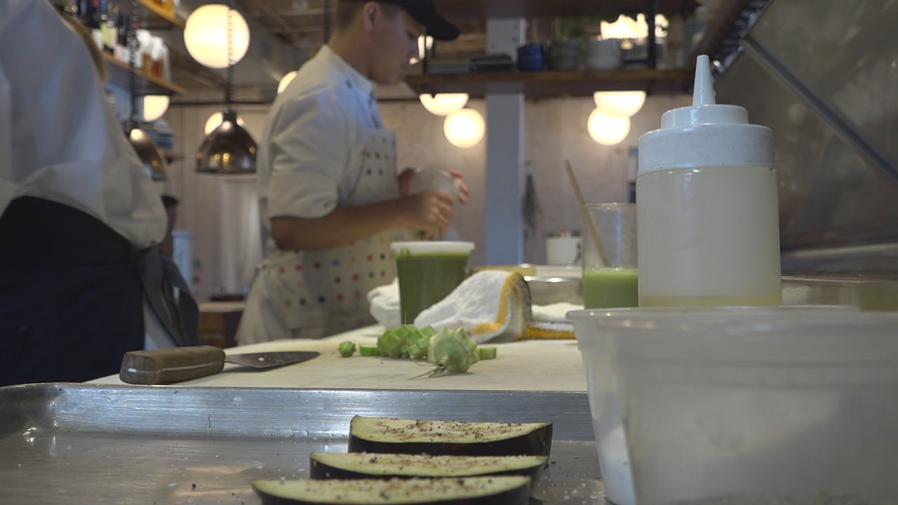 Chefs prepare an eggplant dish at Ronin