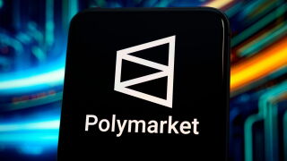 The Polymarket logo is displayed on a cell phone .