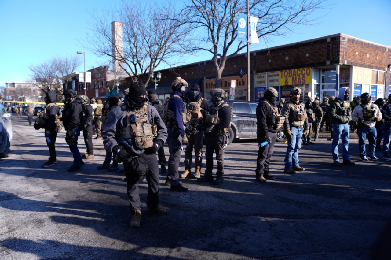 Federal agents stand near the site of a shooting Saturday, Jan. 24, 2026, in Minneapolis, Minn.