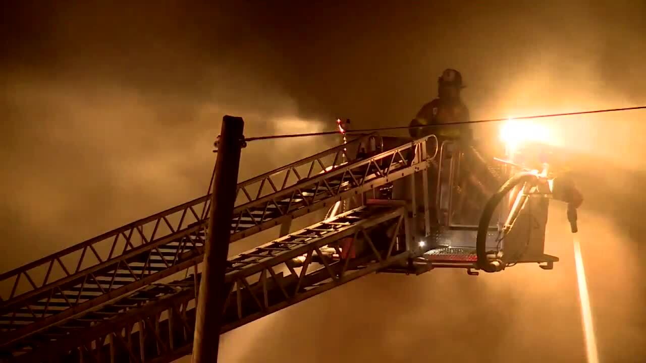 firefighter on ladder truck battles Broadway Avenue fire