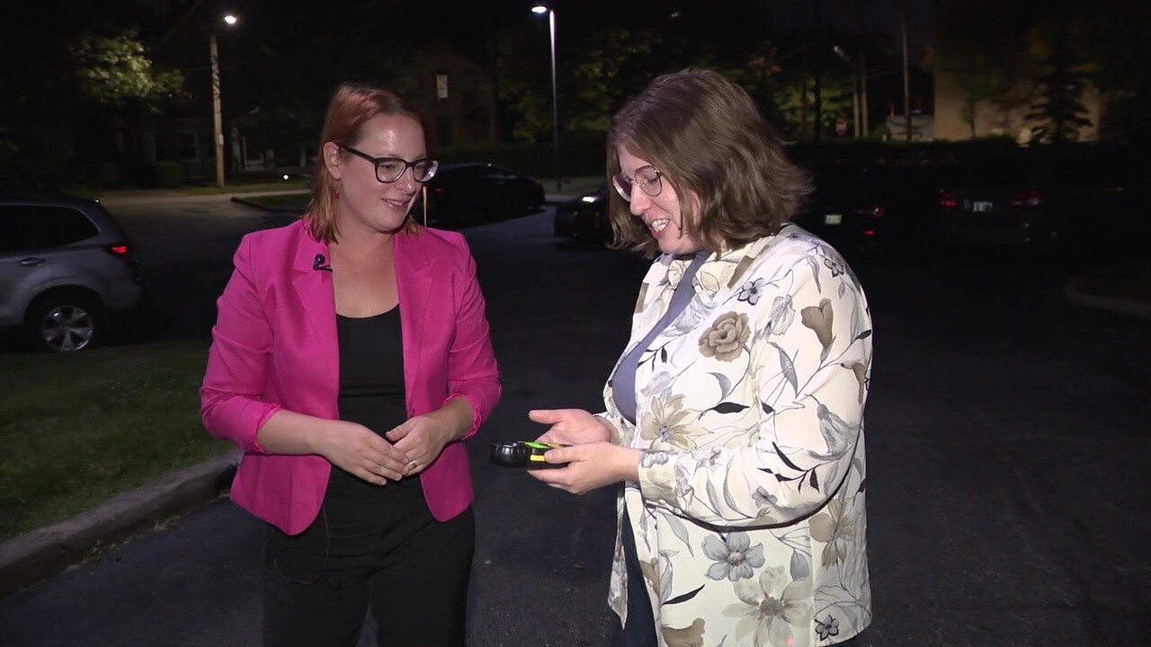 Cleveland Councilwoman Rebecca Maurer, right, shows News 5 reporter Michelle Jarboe how an illuminance meter works.