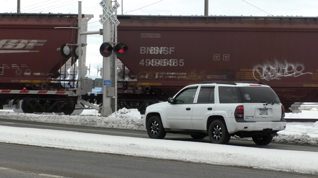 Cars wait for train at Jackrabbit Lane and Main Street intersection in Belgrade.