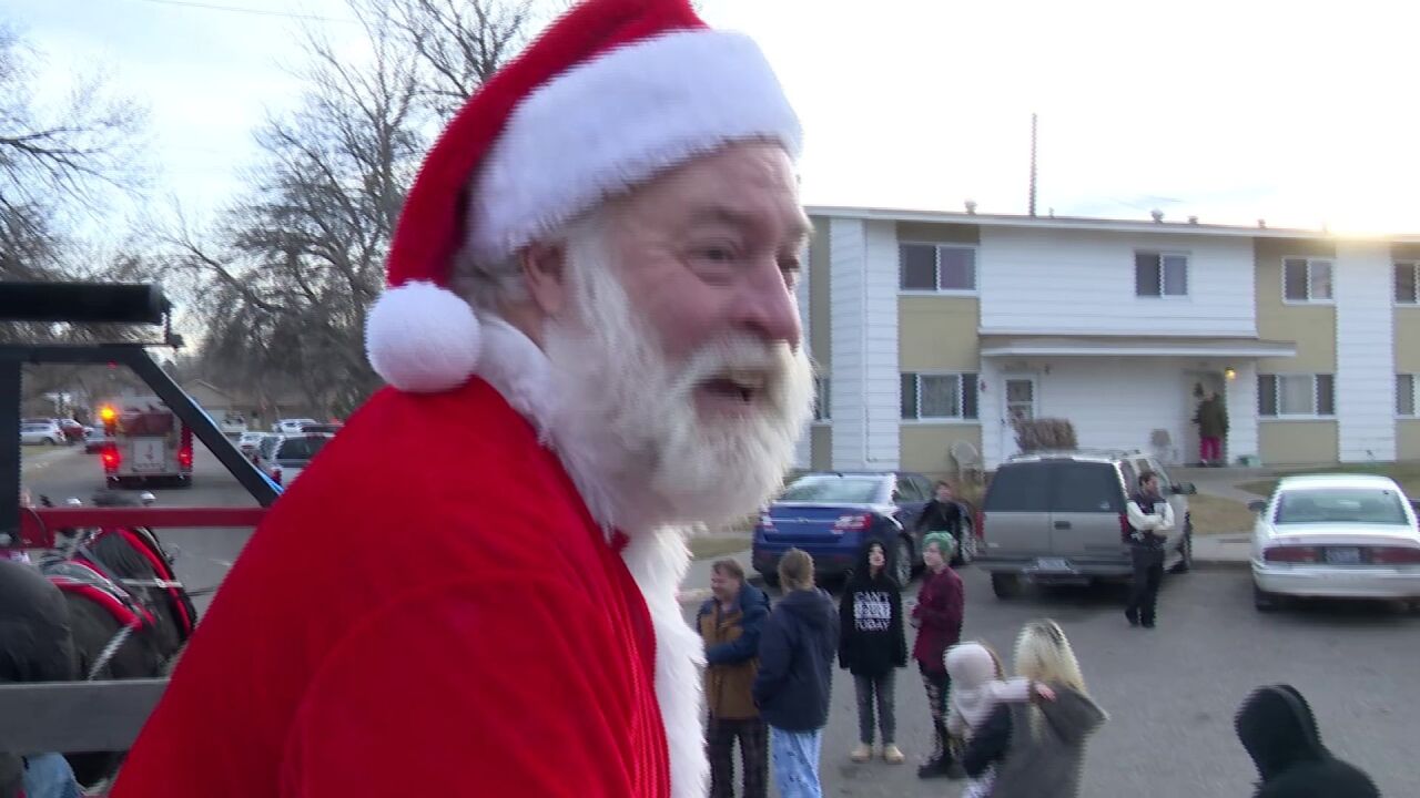 Santa Claus and helpers deliver gifts to Great Falls children
