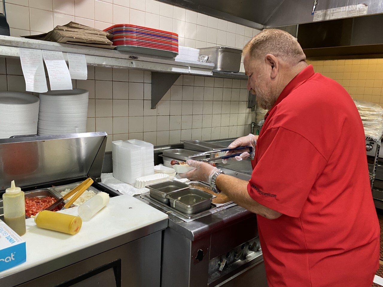 Daniel Contreras making a Sonoran-style hot dog