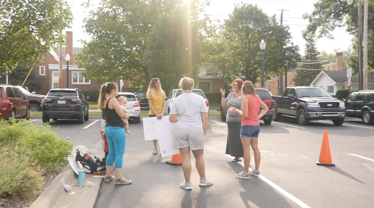 Parents gathered at City Hall to protest the school district's mask requirement