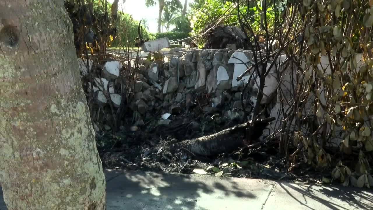hole in concrete wall after fiery crash on Flagler Drive on New Year's Day 2023