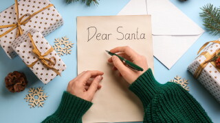 Top,View,Of,Woman,Writing,Letter,To,Santa,At,Light
