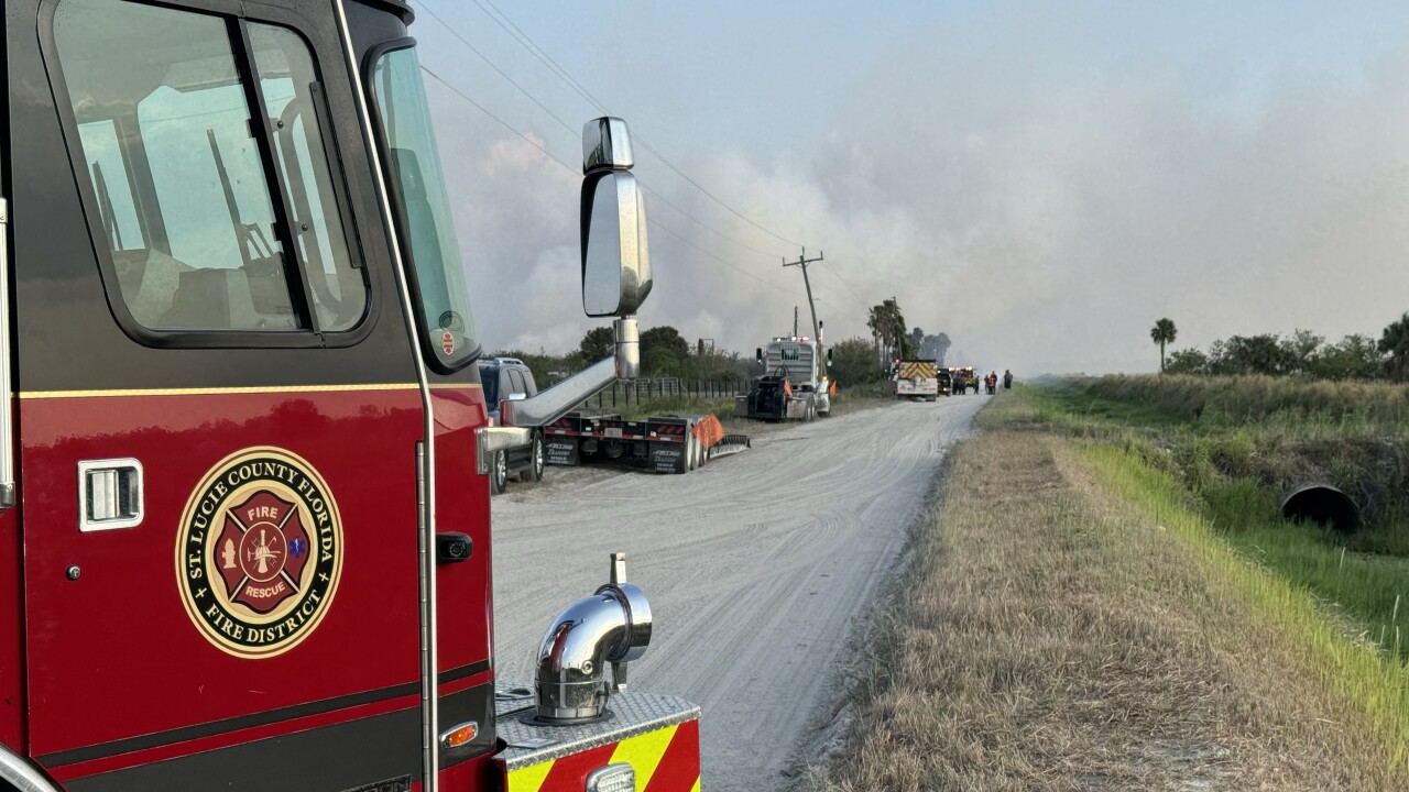 St. Lucie County Fire District truck in foreground of brush fire, May 11, 2024