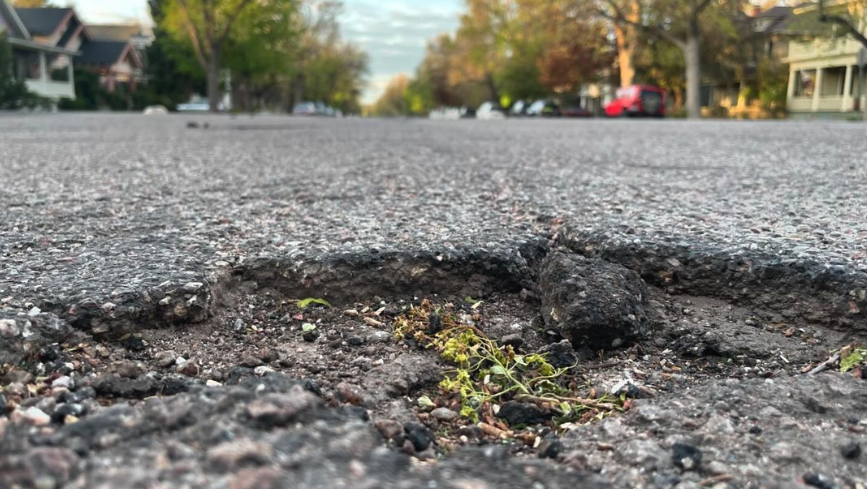 Close up photo of a pothole.