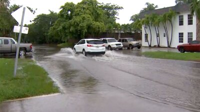 Flooding, generic, car driving through flooded street