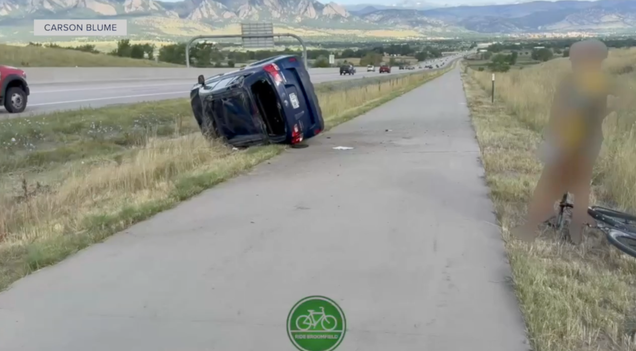 A car on its side after a crash onto the Highway 36 bike path in 2025.