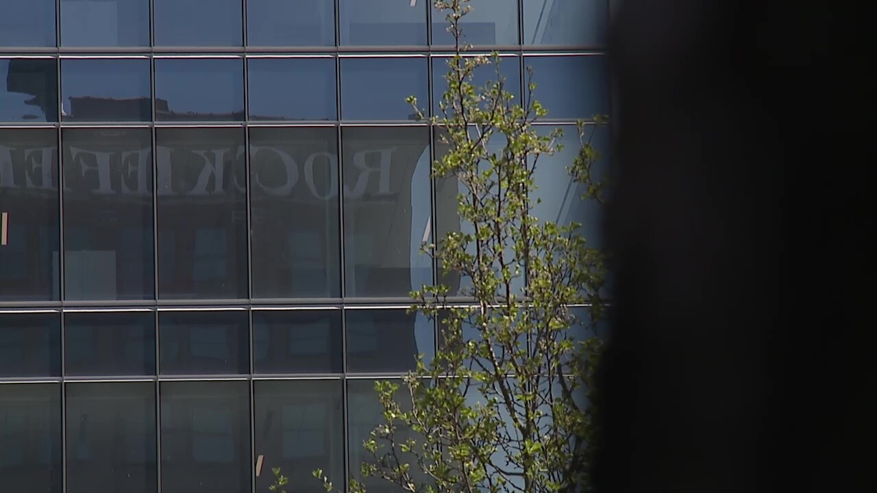 The Rockefeller Building sign is reflected in the new Sherwin-Williams tower across the street.