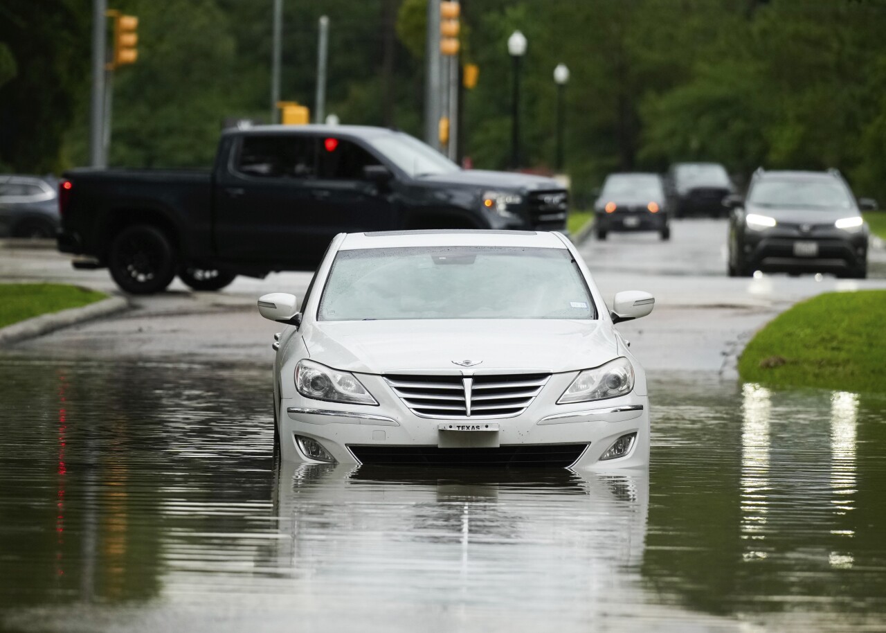 A stalled car is seen in floodwater after severe flooding in a Houston neighborhood.