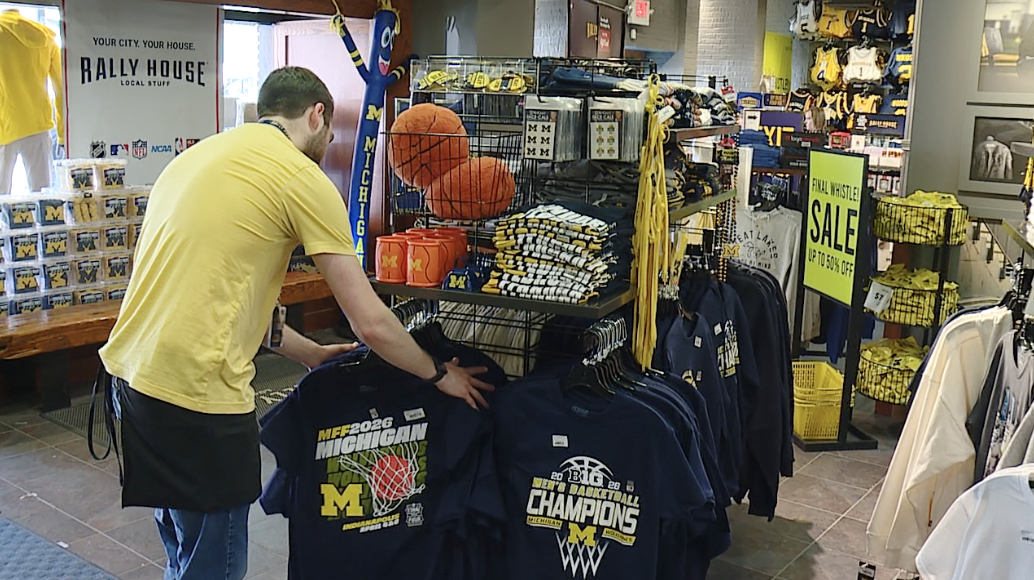 Staff at Rally House in Ann Arbor setting out Final 4 gear