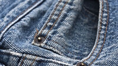 Pocket watch on a pair of jeans.