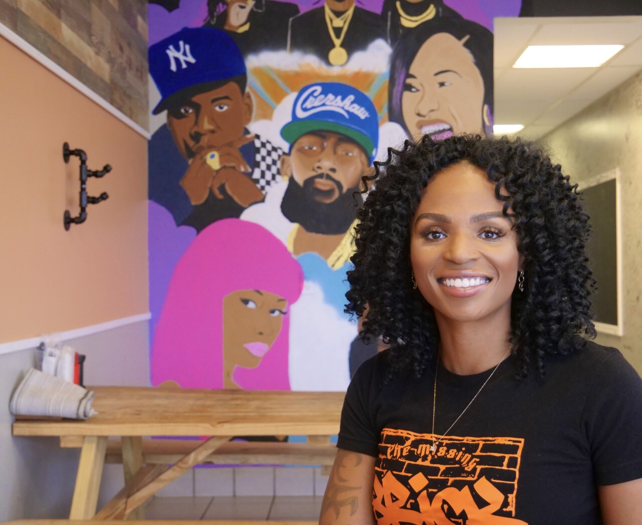 Missing brick pizza owner and mural.jpg