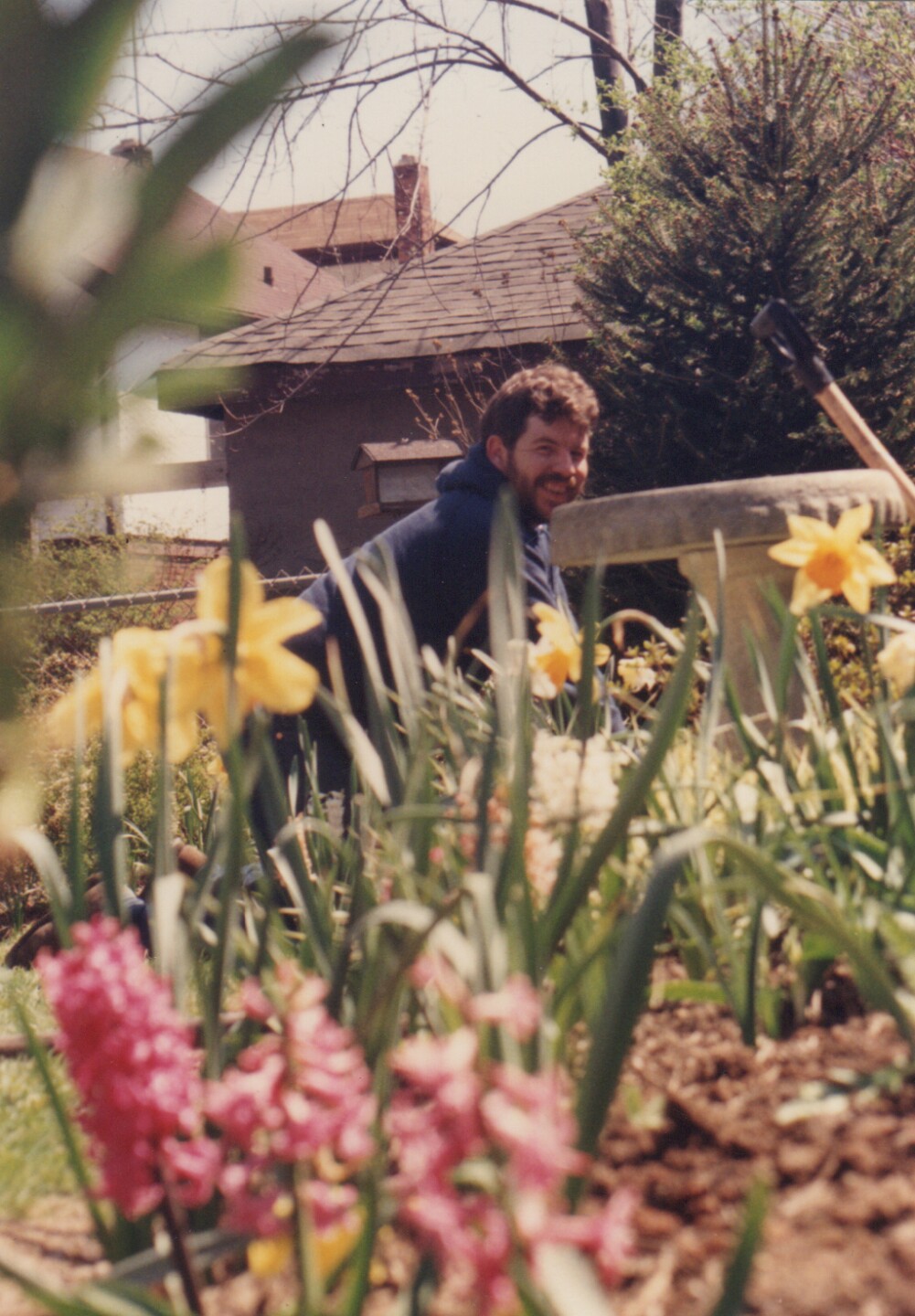 Carl Fox in a photo taken in 1988. The photo was taken outdoors and has flowers in the foreground.