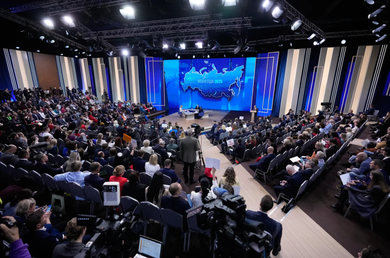 Russian President Vladimir Putin, background center, speaks during his annual news conference and call-in show at Gostinny Dvor, in Moscow, on Friday, Dec. 19, 2025.