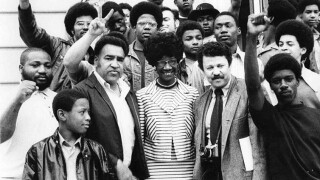 Former presidential candidate Shirley Chisholm smiling and surrounded by supporters