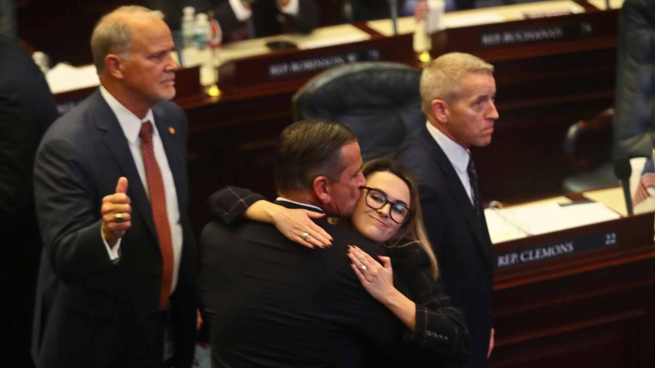 At center, Rep. Bob Rommel, R-Naples kisses Rep. Josie Tomkow, R-Polk City after his SB 2-A Property Insurance bill he co-sponsored passed 84-33 Wednesday, Dec. 14, 2022 in the House of Representatives in Tallahassee, Fla. At left is Rep. Bobby Payne, R-Palatka; at right is House Speaker Paul Renner, R-Palm Coast. Florida lawmakers are meeting to consider ways to shore up the state's struggling home insurance market in the year's second special session devoted to the topic.