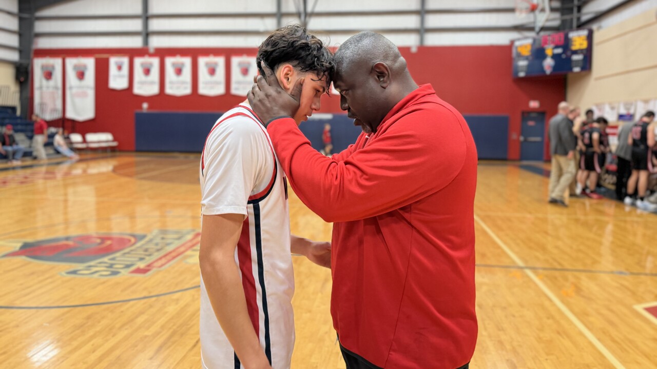 Annapolis Christian Academy boys basketball coach Willie Harper with player