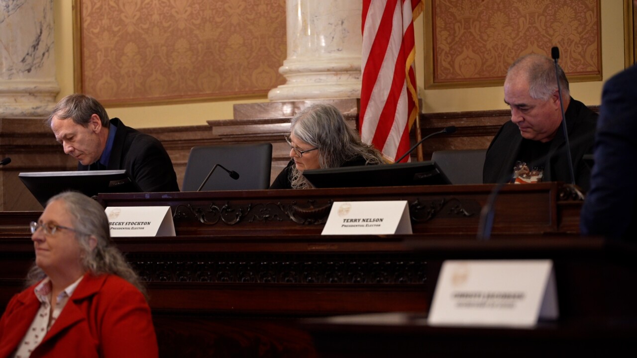 Electors signing ballots