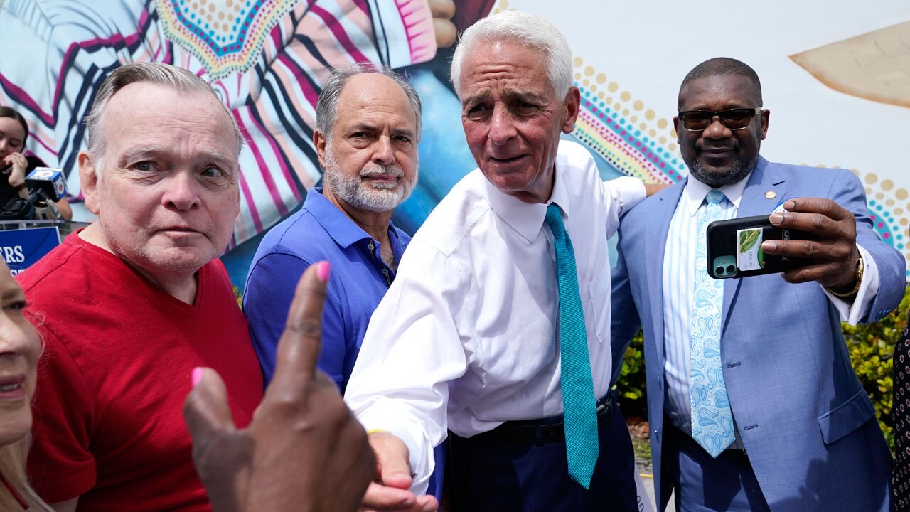 U.S. Rep. Charlie Crist, D-Fla., second from right, talks with a supporter outside of the United Teachers of Dade offices, Tuesday, May 31, 2022, in Miami Springs, Fla.