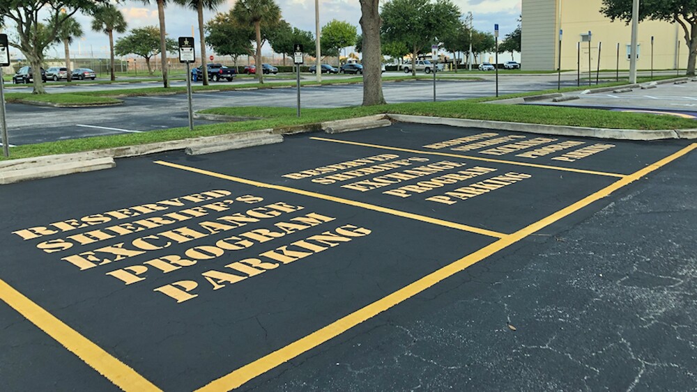Three reserved parking spaces at the Martin County Sheriff's Office designated for selling and buying items online.