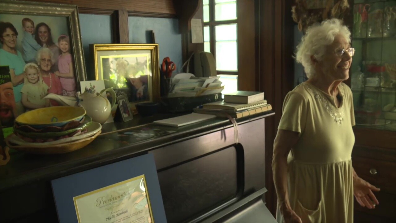 Phyllis Bambeck stands inside her dining room, in an old Cleveland house that hasn't changed much in the last half-century.