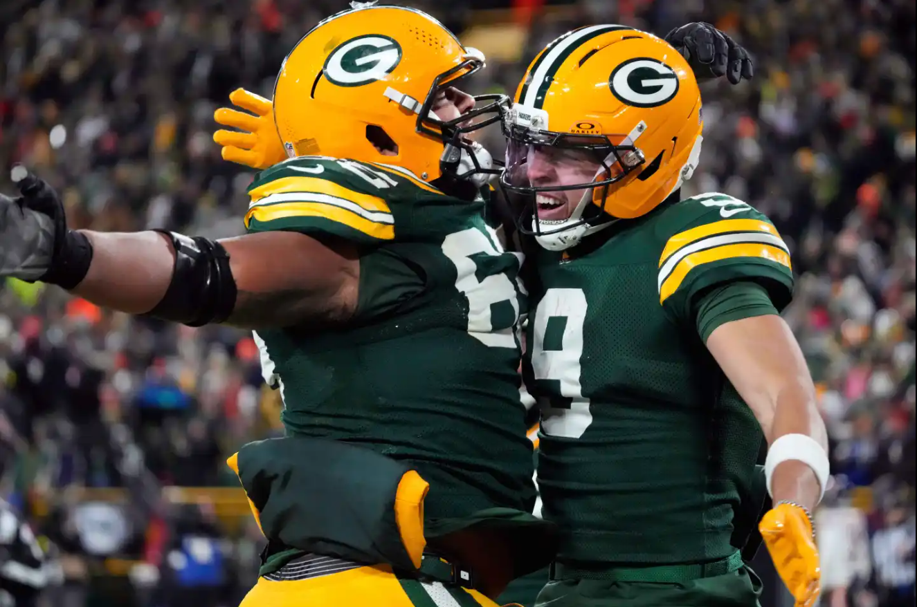 Green Bay Packers wide receiver Christian Watson (9) celebrates with guard Aaron Banks (65) after scoring a touchdown against the Chicago Bears during the second half of an NFL football game Sunday, Dec. 7, 2025, in Green Bay.