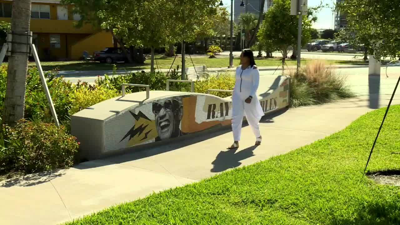 Robyn Charles walks by Ray Charles artwork in West Palm Beach