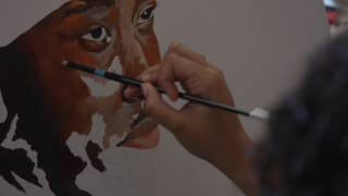 Artist Avry Victor works on a piece from her home studio.
