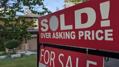A for sale sign in front of a home