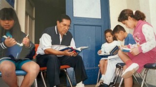 Roy Guerrero tutors kids at the Escondido Union School District. 