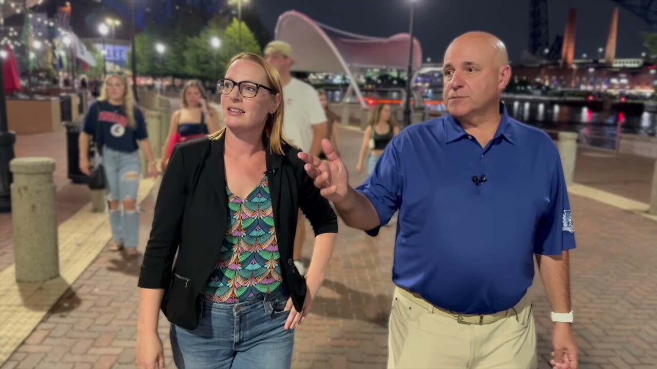 News 5 reporter Michelle Jarboe and George Kimson, of Heritage Development Co., walk along Old River Road at the Flats East Bank project on a Saturday night in mid-August.