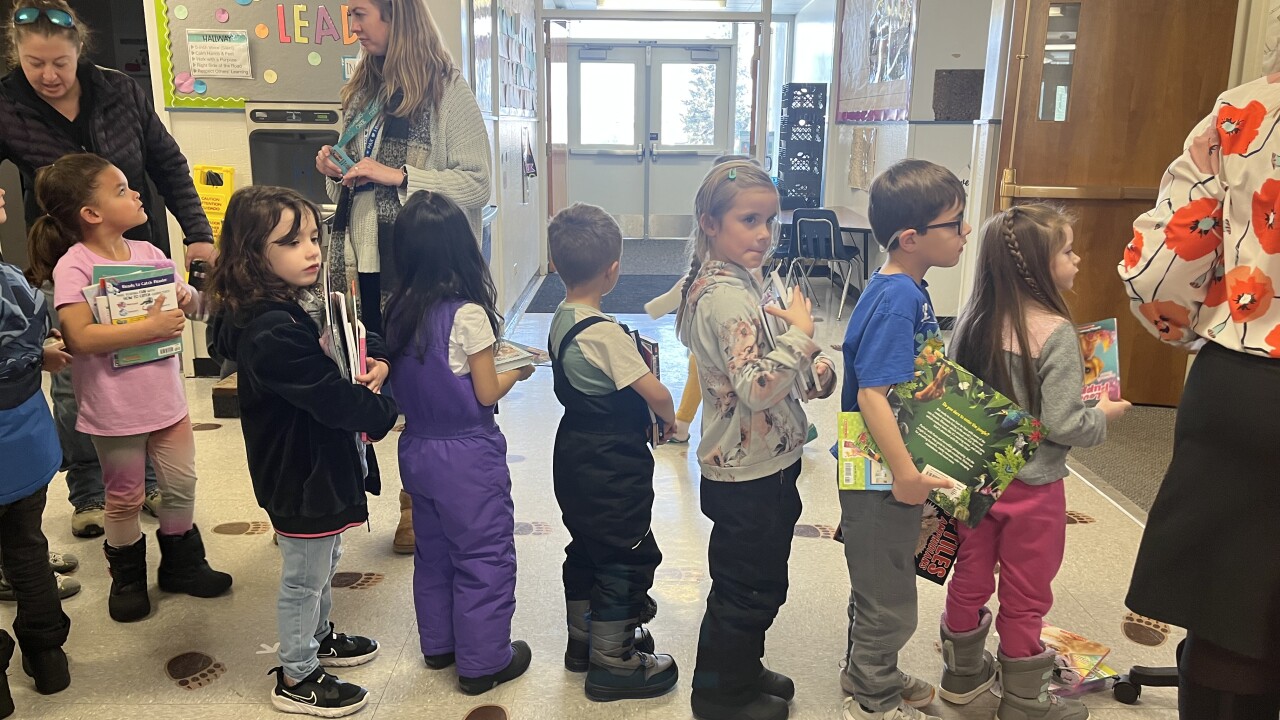 Line of students getting books 