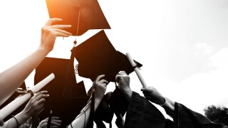 Group,Of,Graduate,Students,Throwing,Graduation,Hats,To,The,Sky.