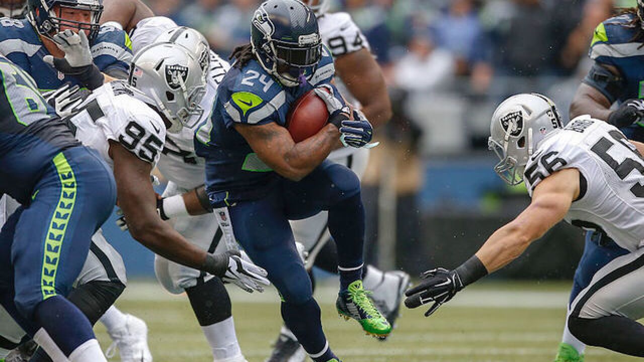 Marshawn Lynch takes a seat during National Anthem