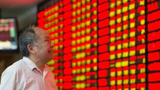 A Chinese trader looks at stock market numbers.