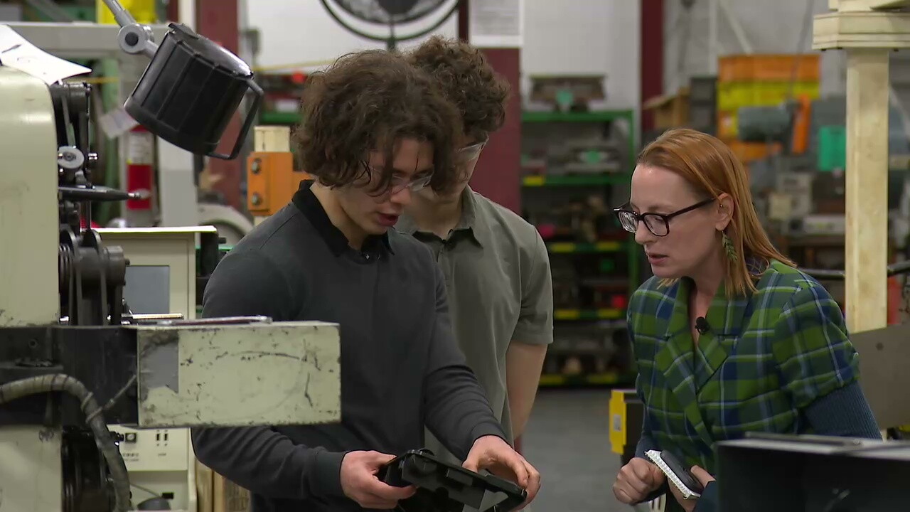 Nolan Pastor, an engineer at family-owned Ampex Metal Products, shows News 5 reporter Michelle Jarboe how the company's parts are used in vacuum cleaners.