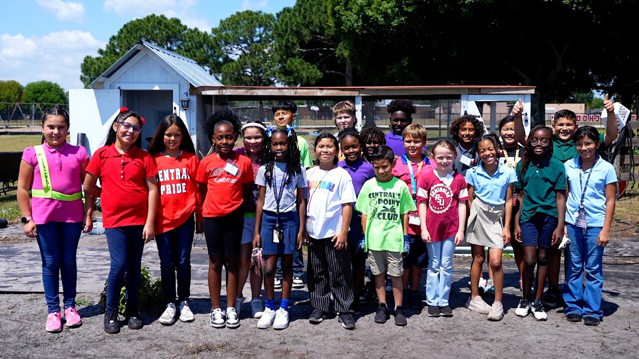 Group of students gathered for a group photo in their garden.