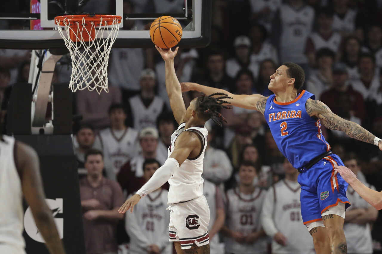 South Carolina Gamecocks guard Meechie Johnson makes layup over Florida Gators guard Riley Kugel during first half, March 2, 2024