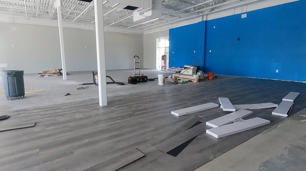 Work continues inside the new pet supply store in Boynton Beach amid supply chain problems.