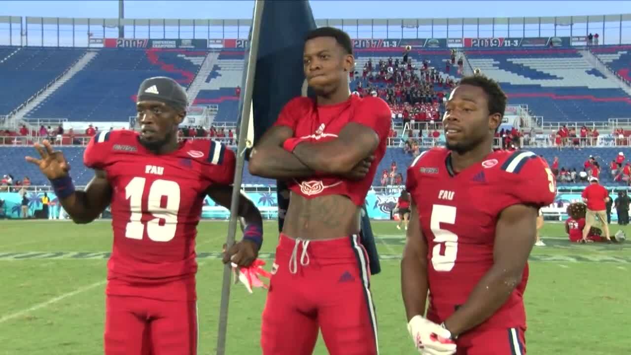 FAU Owls QB N'Kosi Perry celebrates with teammates after beating FIU Panthers in 2021