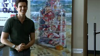 Kyle Lucks alongside his painting titled: "Florida Panthers: Reflections of Victory".
