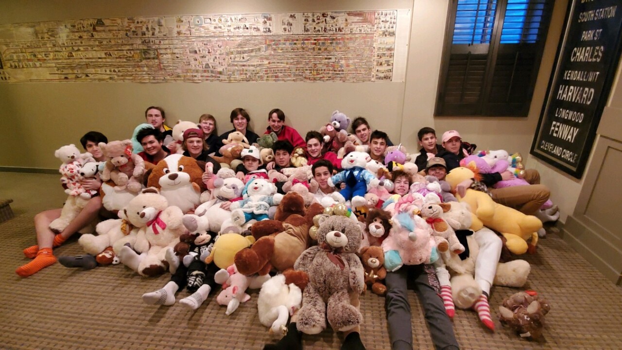 Regis Jesuit Hockey - team with kids teddy bears.jpg