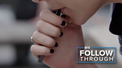 Person sucking on vape pen