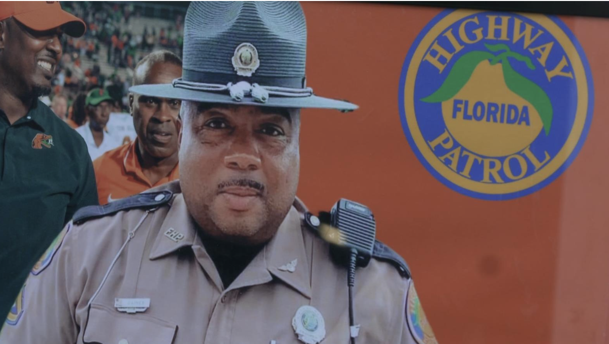 The family of Trooper Craig Gaines keeps framed photos of him providing security for FAMU’s football coach.