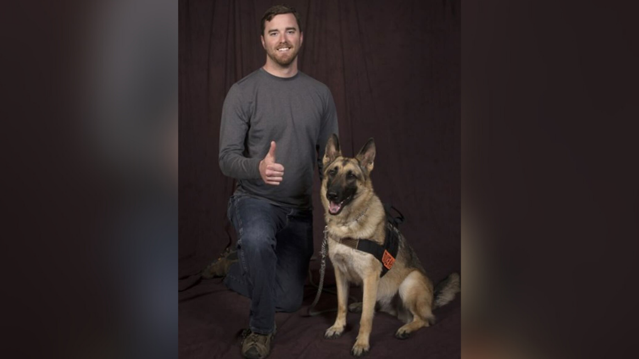 Cole Lyle and his service dog Kaya.png